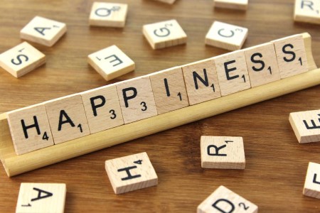 scrabble letters spelling out happiness